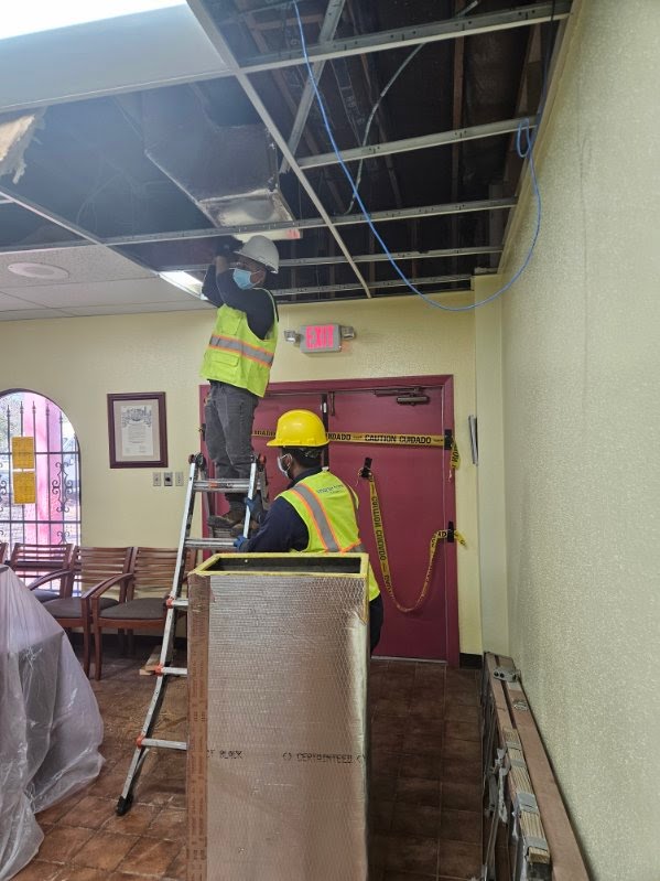 New ADA-compliant concrete curb cuts and accessible parking spaces at a local business entrance.
