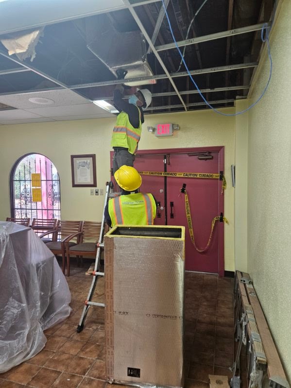 Professional installation of modern ADA-compliant silver door lever hardware for commercial accessibility.