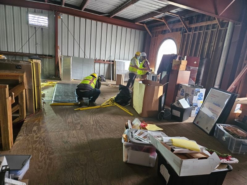 Contractors and city officials reviewing blueprints for the HEART facility renovation project.